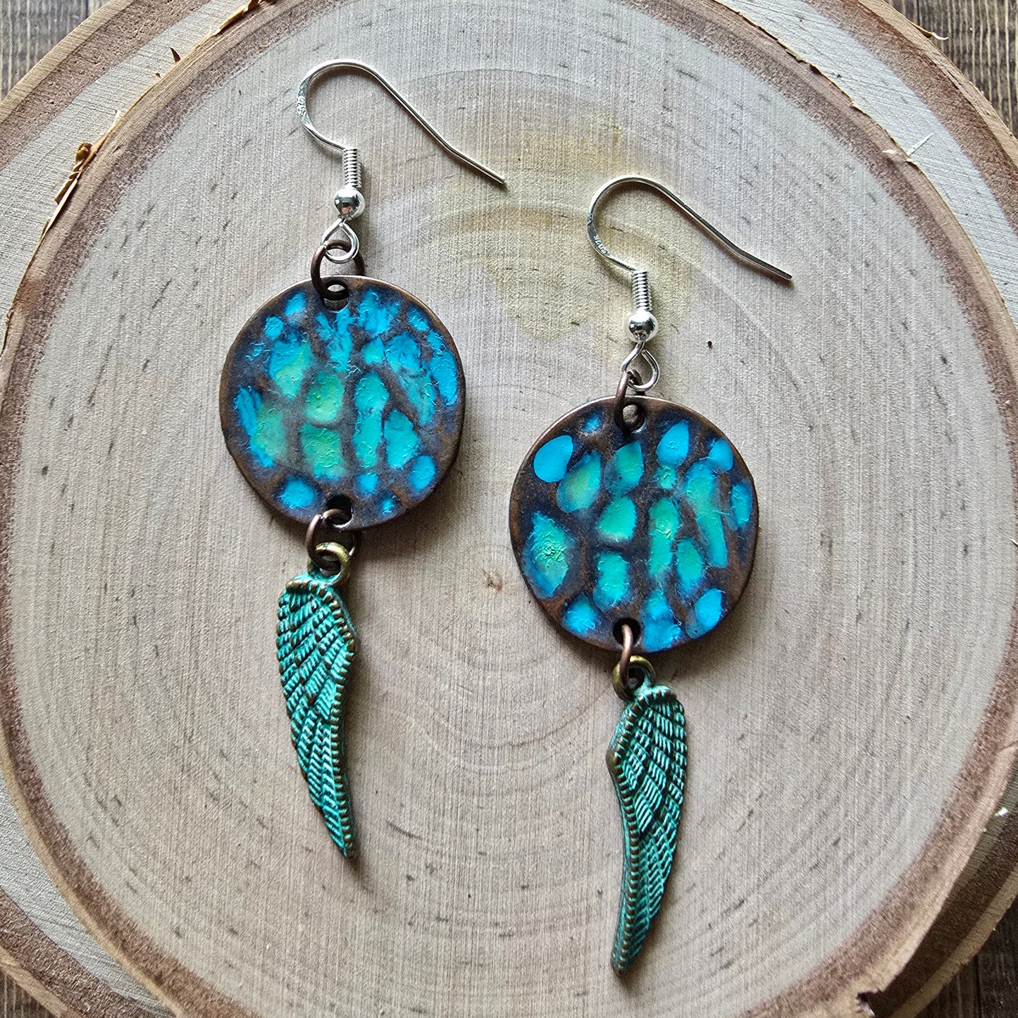 Patina metal disc and angel wing dangle earrings