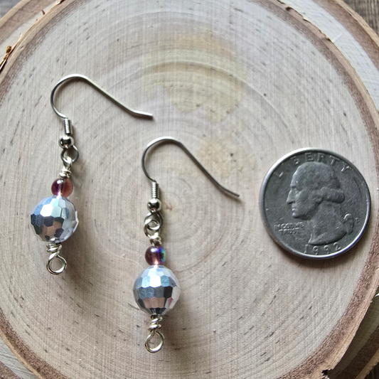Faceted glass and purple iridescent dangle earrings