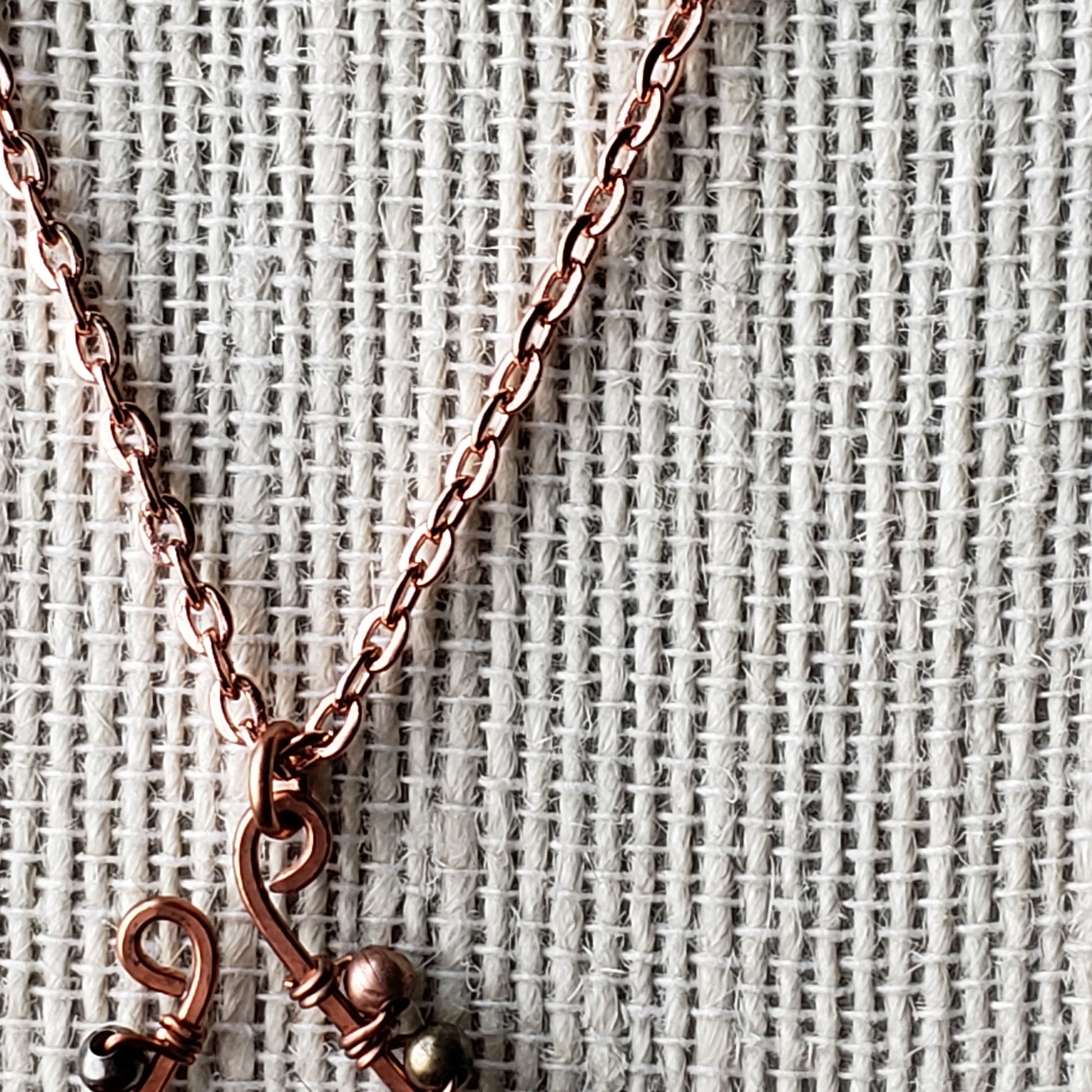 Wire wrapped hand hammered copper elongated horseshoe necklace