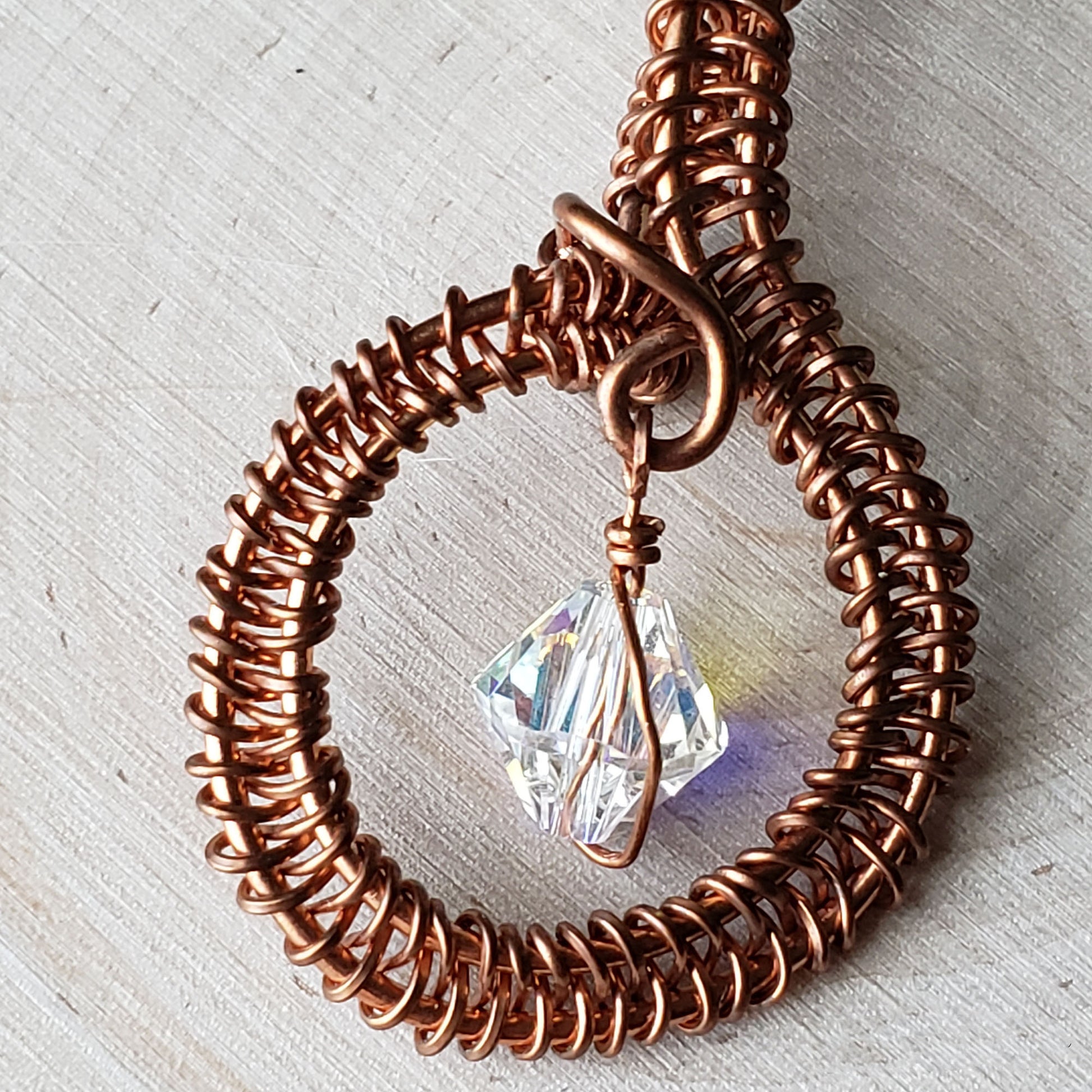 Round copper pendant with clear Swarovski crystal accent bead