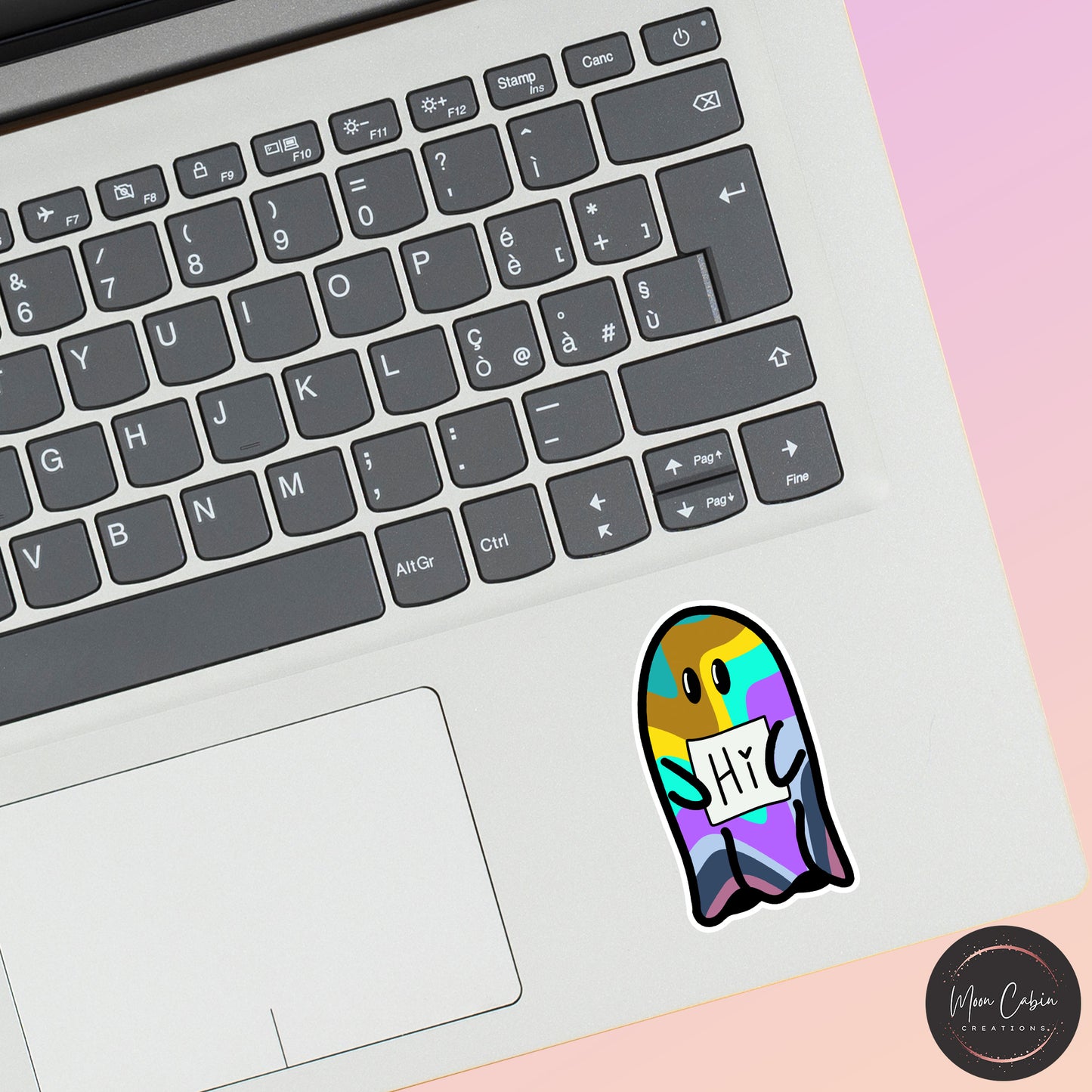 Vibrant happy ghost hand drawn vinyl sticker, on laptop